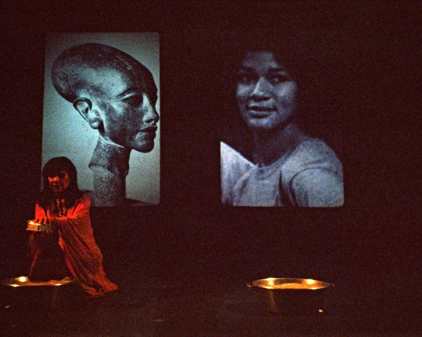 Instead of the “beef heart” described on the soundtape, she lifts a heart of sand, performance Nefertiti/Devonia Evangeline by Lorraine O’Grady.