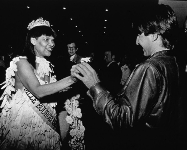 Mlle Bourgeoise Noire asks, Won't you help me lighten my heavy bouquet? Mlle Bourgeoise Noire performance by Lorraine O'Grady.