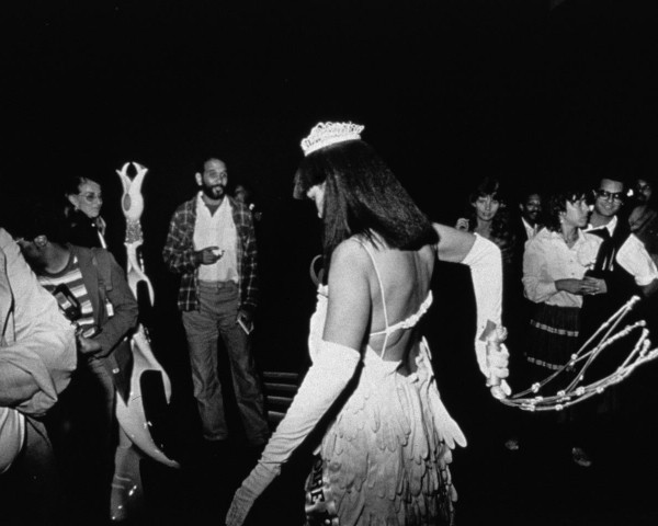 Crowd watches Mlle Bourgeoise Noire whipping herself. Mlle Bourgeoise Noire performance by Lorraine O'Grady.