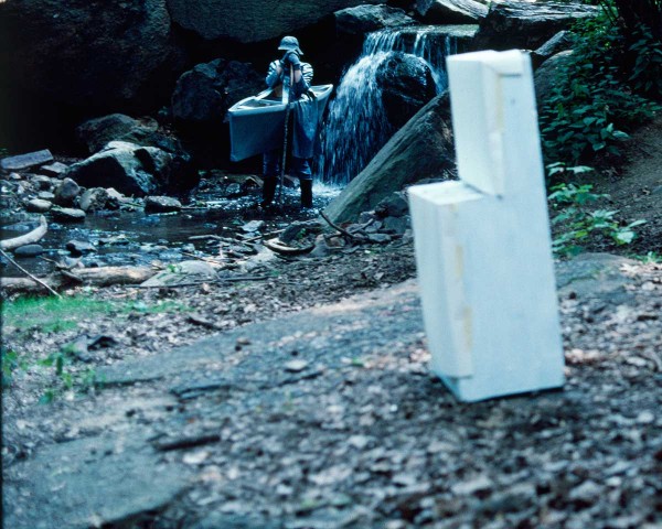 She descends to the stream where the white stove is standing, performance Rivers First Draft by Lorraine O’Grady.