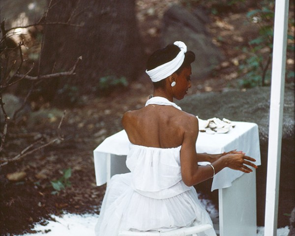 The Woman in White works impassively, performance Rivers First Draft by Lorraine O’Grady.