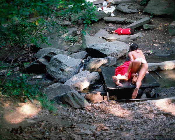 As if from its pages, the Nude Swimmer emerges from the water and fondles her, performance Rivers First Draft by Lorraine O’Grady.